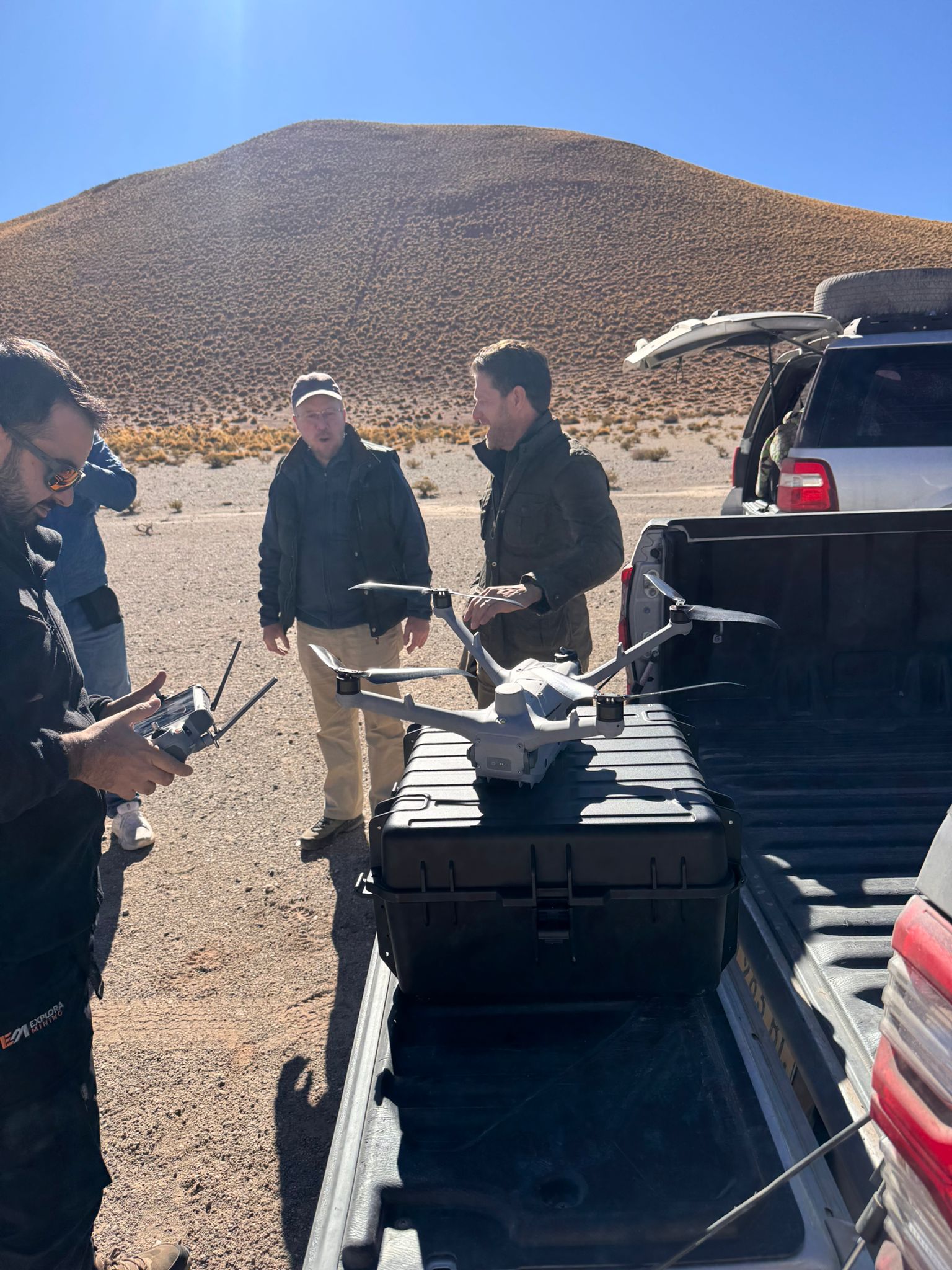 Team preparing a reconnaissance drone on a hard case in the back of a pickup